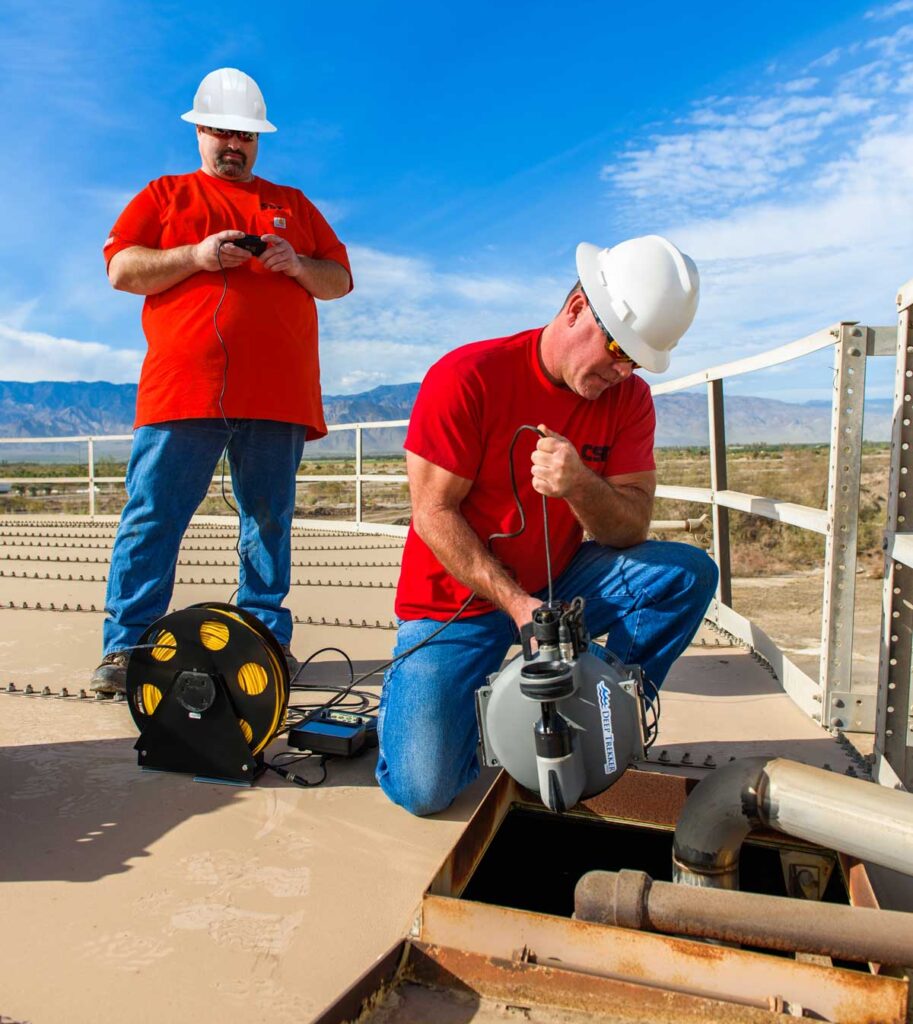 Workers at the top of a tank inspection